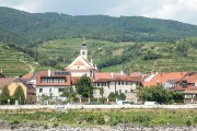hillsides of vineyards and village along the river